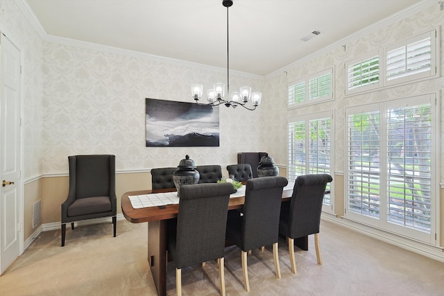 carpeted dining space with an inviting chandelier and ornamental molding