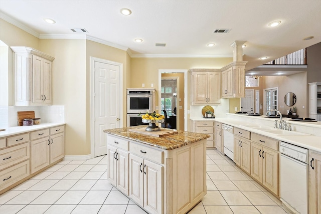 kitchen with crown molding, double oven, sink, and white dishwasher