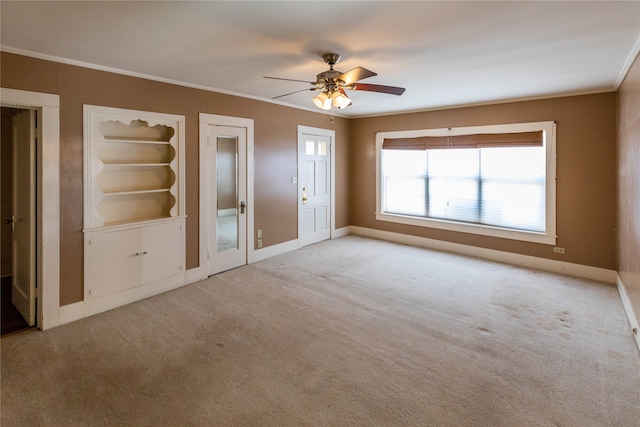 unfurnished living room featuring ceiling fan, light colored carpet, and crown molding