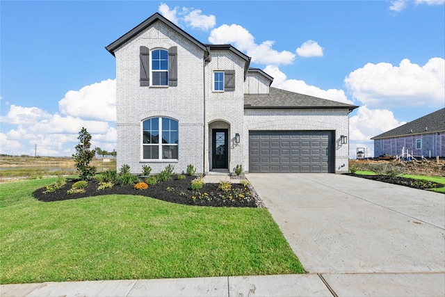 french provincial home featuring a garage and a front yard