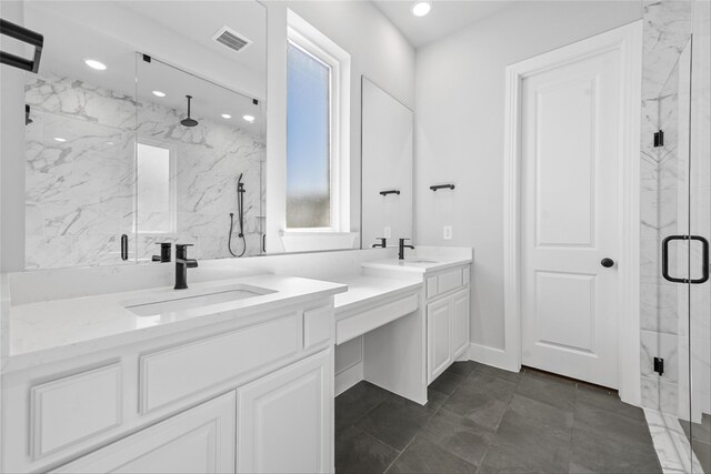 bathroom featuring vanity and an enclosed shower