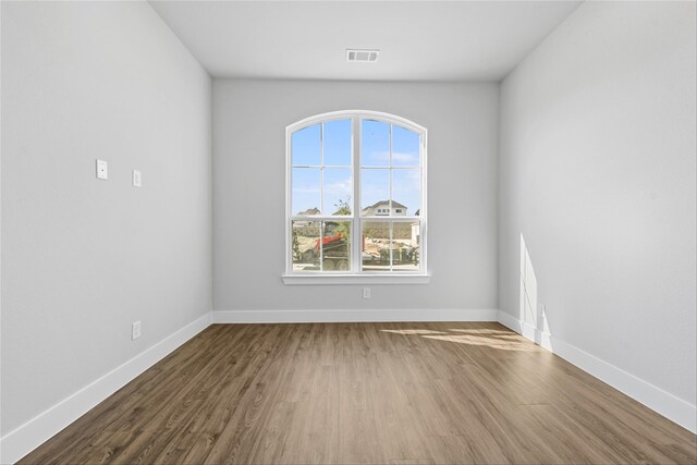 empty room with hardwood / wood-style flooring