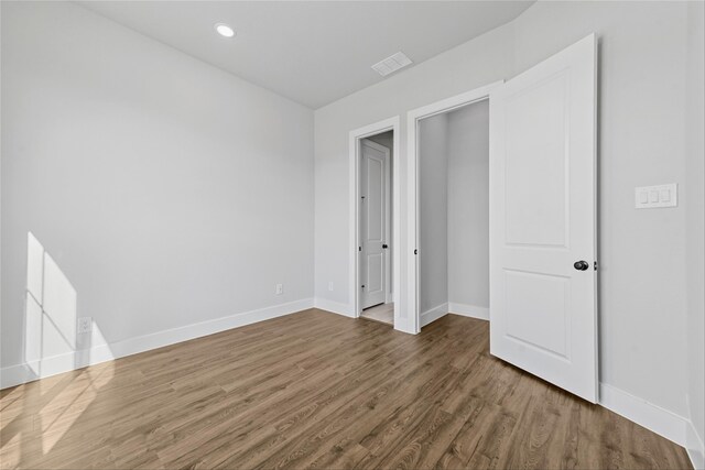 unfurnished bedroom featuring hardwood / wood-style floors