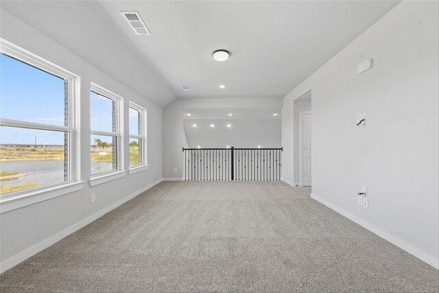 unfurnished living room with light carpet and lofted ceiling