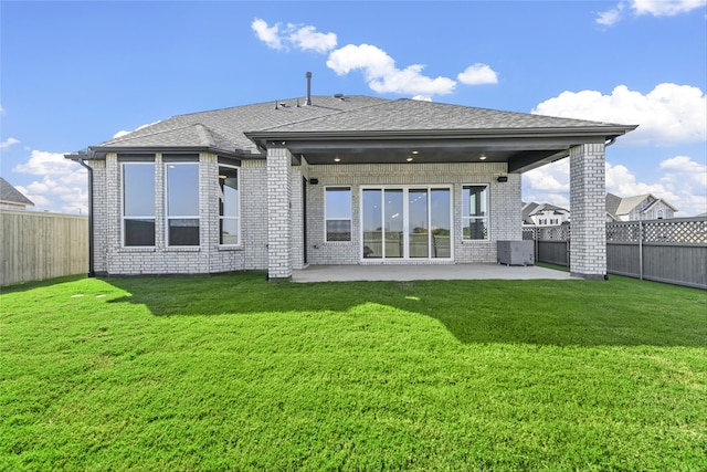 back of house featuring central air condition unit, a patio area, and a yard