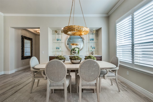 dining area featuring a wealth of natural light, crown molding, and hardwood / wood-style flooring