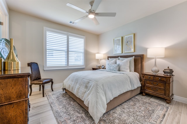 bedroom with light hardwood / wood-style floors and ceiling fan