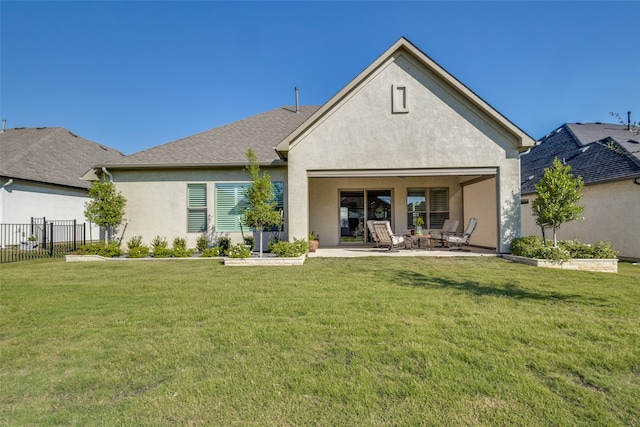 back of property with a patio and a yard