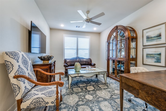 living area with ceiling fan