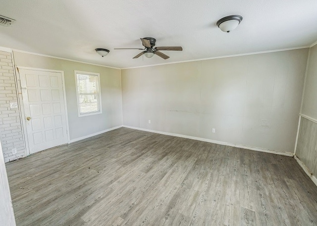 spare room with ornamental molding, ceiling fan, and hardwood / wood-style floors