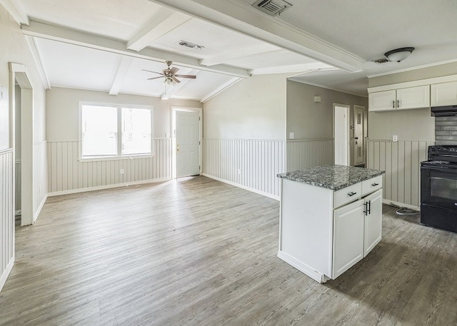 kitchen featuring black / electric stove, white cabinetry, hardwood / wood-style floors, and lofted ceiling with beams