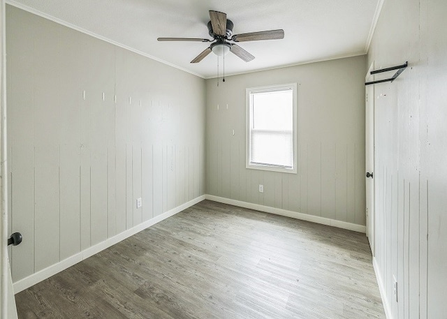 spare room featuring ceiling fan, light hardwood / wood-style flooring, and crown molding