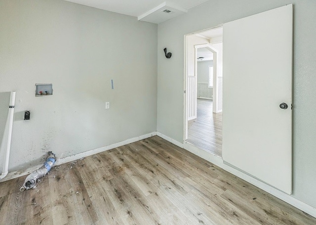 laundry room featuring washer hookup and light wood-type flooring