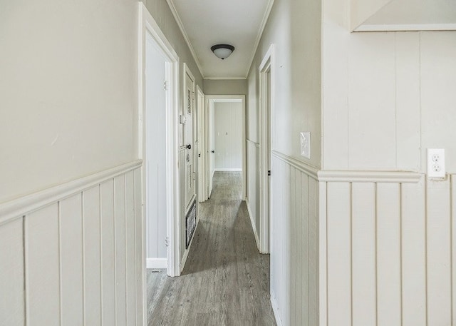 hallway with hardwood / wood-style flooring and crown molding