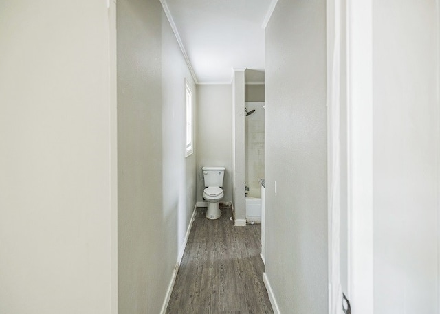 corridor with ornamental molding and dark hardwood / wood-style flooring