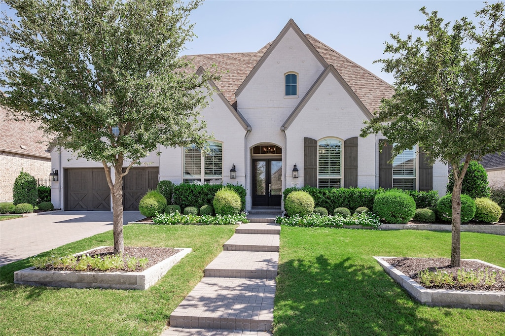 view of front of house with a front yard and a garage