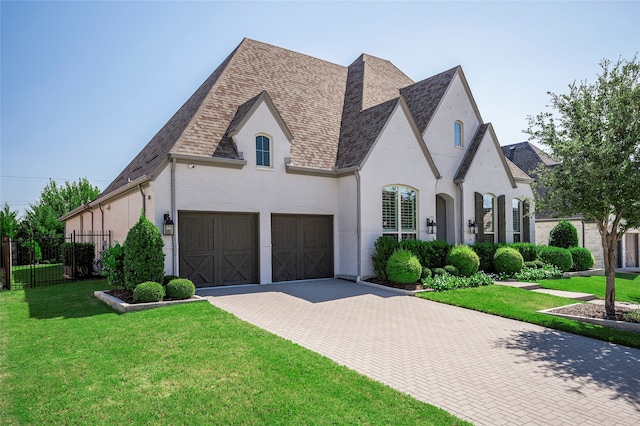 view of front of property with a garage and a front lawn