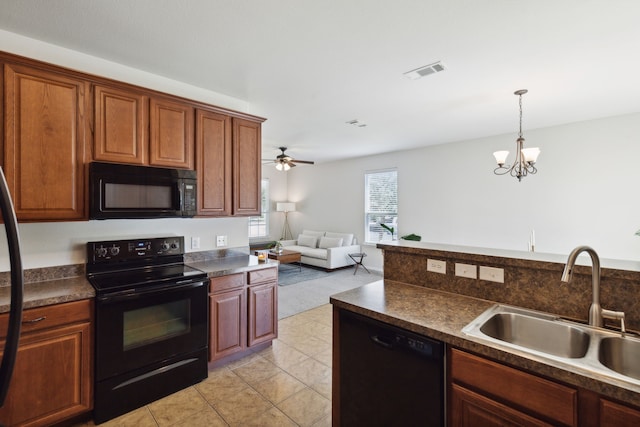 kitchen featuring light tile patterned flooring, sink, ceiling fan with notable chandelier, hanging light fixtures, and black appliances