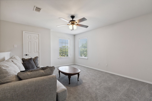 carpeted living room featuring ceiling fan