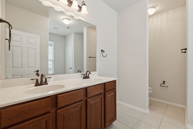 bathroom featuring vanity, tile patterned flooring, and toilet