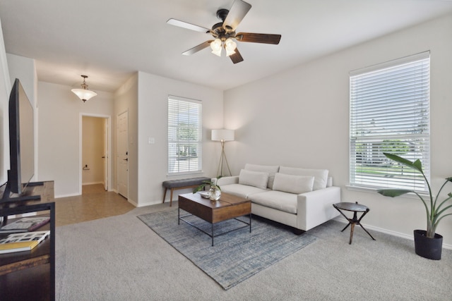 carpeted living room with ceiling fan and a wealth of natural light