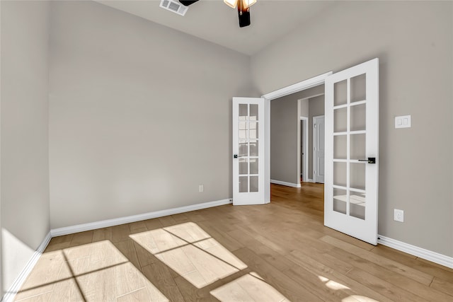 unfurnished room with french doors, hardwood / wood-style flooring, and ceiling fan