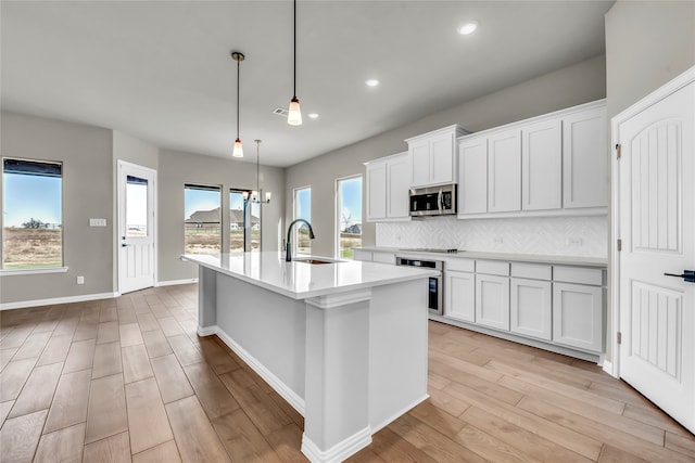 kitchen with sink, white cabinets, and appliances with stainless steel finishes