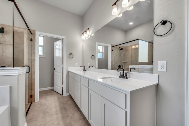 bathroom featuring vanity, a shower with door, and a healthy amount of sunlight