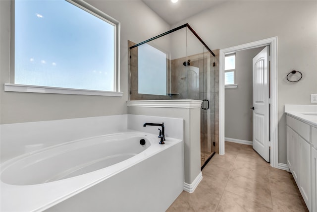 bathroom with tile patterned floors, plenty of natural light, shower with separate bathtub, and vanity