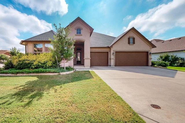 view of front facade with a front yard and a garage