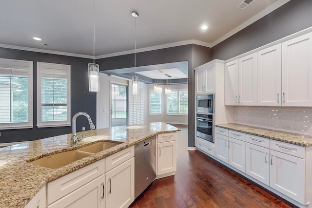 kitchen with white cabinets, sink, appliances with stainless steel finishes, dark hardwood / wood-style floors, and a wealth of natural light