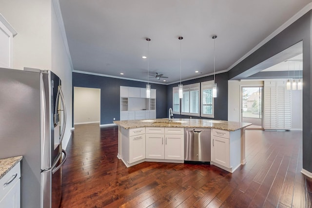 kitchen with ceiling fan, white cabinets, pendant lighting, appliances with stainless steel finishes, and dark hardwood / wood-style floors