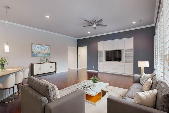 living room featuring wood-type flooring, ornamental molding, and ceiling fan