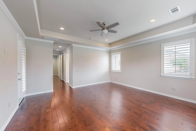 unfurnished room featuring ornamental molding, dark wood-type flooring, and a wealth of natural light