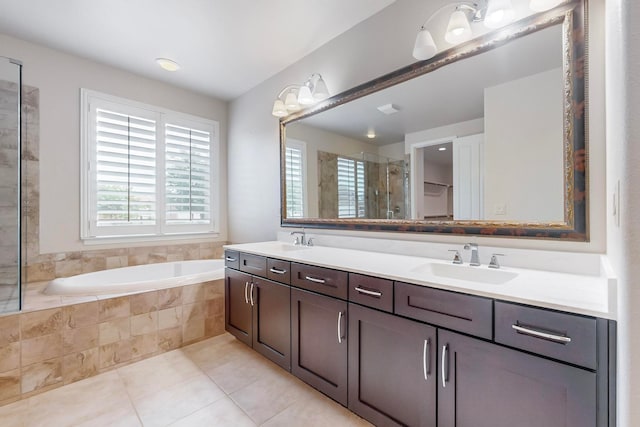 bathroom with plus walk in shower, tile patterned floors, and vanity