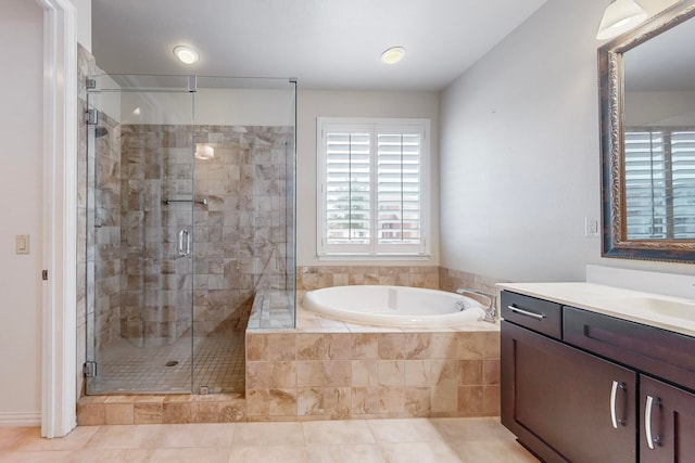 bathroom with tile patterned flooring, vanity, and separate shower and tub