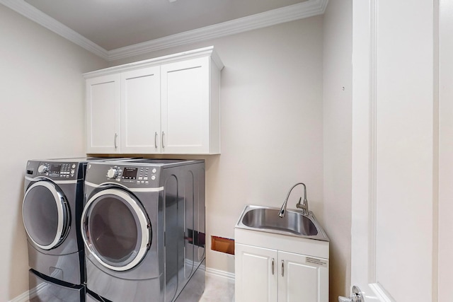 laundry area with separate washer and dryer, cabinets, crown molding, and sink