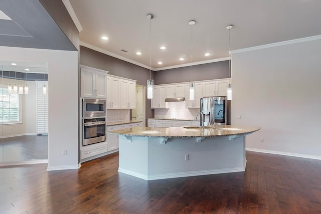 kitchen with white cabinetry, dark wood-type flooring, tasteful backsplash, stainless steel appliances, and decorative light fixtures