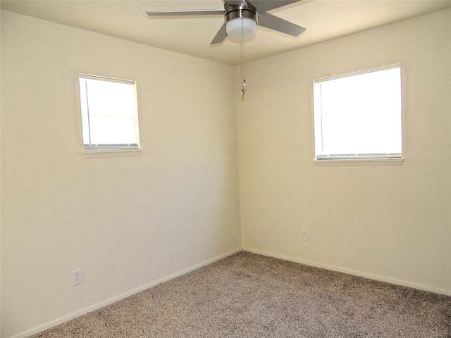 spare room featuring carpet flooring, ceiling fan, and plenty of natural light