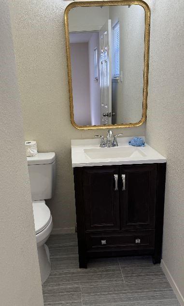 bathroom featuring vanity and toilet