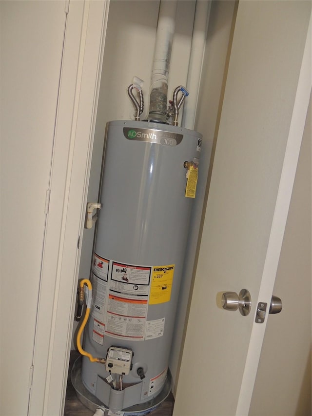 utility room featuring water heater