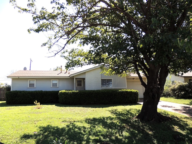 view of front of property with a garage and a front yard