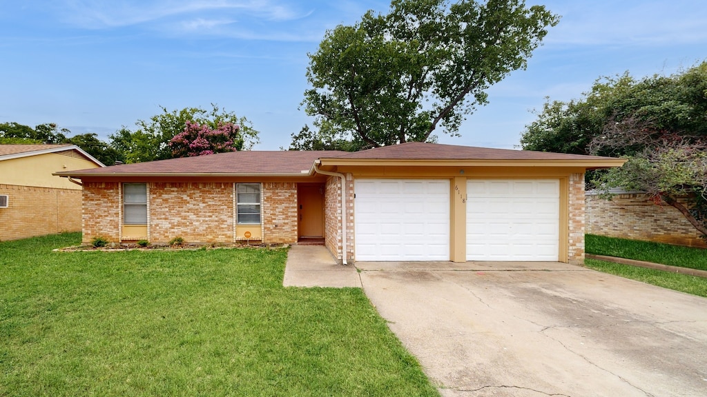 ranch-style house with a garage and a front yard