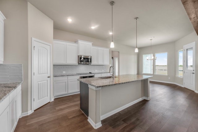 kitchen featuring sink, decorative backsplash, light stone countertops, dark hardwood / wood-style floors, and white cabinetry