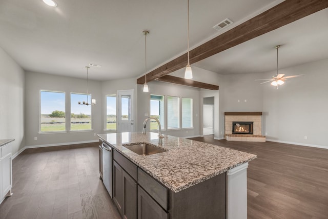 kitchen featuring hanging light fixtures, dark hardwood / wood-style floors, dark brown cabinetry, and sink