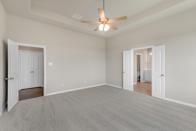 unfurnished bedroom with light colored carpet and ceiling fan