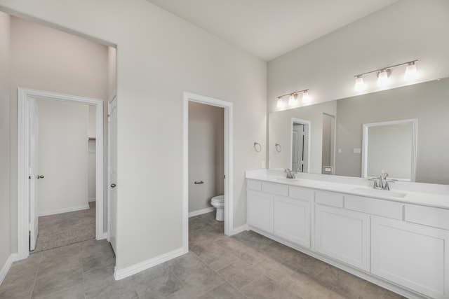 bathroom featuring tile patterned flooring, vanity, and toilet