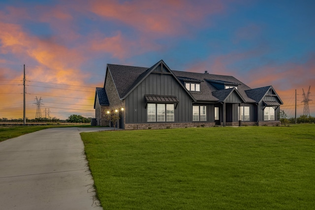 modern inspired farmhouse with a lawn