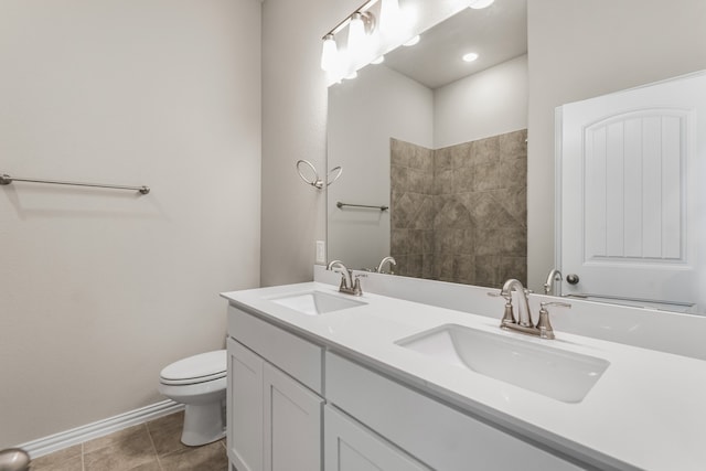 bathroom featuring vanity, tile patterned flooring, and toilet