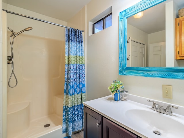 bathroom with walk in shower and vanity